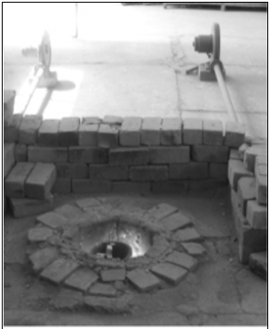 Fig. 1: (a) Falling weight impact tester model CEAST 9340, and (b) specimen clamped inside thermal conditioning chamber of impact tester